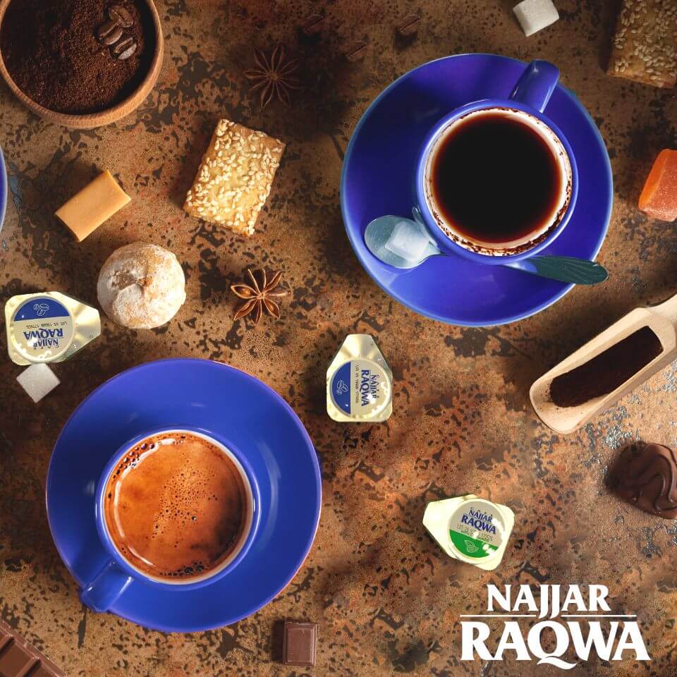 Najjar Raqwa Coffee Machine brewing espresso-style coffee with blue cups, candy, and coffee accessories.